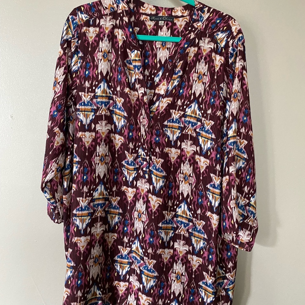 Maroon, patterned blouse with half sleeves.